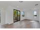 Bright, airy living room with hardwood floors and sliding glass doors leading to a balcony at 100 W Northern Ave # 15, Phoenix, AZ 85021