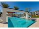 Inviting pool area with a water feature, cabanas, and an outdoor kitchen at 100 W Northern Ave # 15, Phoenix, AZ 85021
