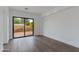 Bright room features sleek hardwood floors and a large sliding glass door to the backyard at 100 W Northern Ave # 15, Phoenix, AZ 85021