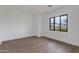 Bright room with wood floors, a large window, and view of the neighborhood at 100 W Northern Ave # 15, Phoenix, AZ 85021
