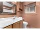 Bathroom featuring a window, framed mirror, updated sink and vanity with a toilet at 10418 W Corte Del Sol Oeste --, Sun City, AZ 85351
