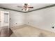 Bedroom featuring a ceiling fan, carpet, and a entrance to another room at 10418 W Corte Del Sol Oeste --, Sun City, AZ 85351