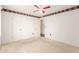 Neutral carpeted bedroom with white walls, ceiling fan, closet, and door at 10418 W Corte Del Sol Oeste --, Sun City, AZ 85351