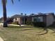 Traditional-style brick home with white shutters, complemented by green landscaping at 10418 W Corte Del Sol Oeste --, Sun City, AZ 85351