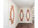 Hallway with decorative doors and hardwood floors leading to a bright interior at 10418 W Corte Del Sol Oeste --, Sun City, AZ 85351