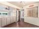Open kitchen with stainless steel refrigerator, hardwood floors and bar-top seating at 10418 W Corte Del Sol Oeste --, Sun City, AZ 85351