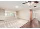 Spacious living room with hardwood and carpet flooring, built in shelving, and lots of natural light at 10418 W Corte Del Sol Oeste --, Sun City, AZ 85351