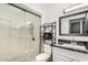 Modern bathroom featuring a glass-enclosed shower, sleek vanity, and contemporary fixtures at 10461 W Hutton Dr, Sun City, AZ 85351