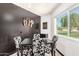 Cozy dining area showcasing a modern table with black and white chairs, bright window, and decor at 10461 W Hutton Dr, Sun City, AZ 85351