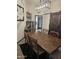 Dining area features a wooden table with chairs, a sliding barn door, and stylish decor, creating a cozy and inviting space at 10461 W Hutton Dr, Sun City, AZ 85351