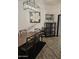 A bright dining room showcases a wooden table, bar cabinet, pendant light, and a neutral color scheme, offering an elegant setting at 10461 W Hutton Dr, Sun City, AZ 85351