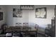Cozy dining room featuring modern light fixture and flower artwork over a dark wood dining table with 6 chairs at 10461 W Hutton Dr, Sun City, AZ 85351