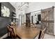 Stylish dining room featuring a wooden table, decor, and barn doors leading to the living room at 10461 W Hutton Dr, Sun City, AZ 85351