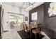 Elegant dining room with a modern light fixture, neutral walls, and sliding glass doors to the backyard at 10461 W Hutton Dr, Sun City, AZ 85351