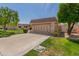 Home with a well-kept lawn, neat landscaping, and a driveway leading to a convenient two-car garage at 10461 W Hutton Dr, Sun City, AZ 85351