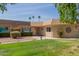 Inviting single story home features a lush green lawn and mature landscaping for enhanced curb appeal at 10461 W Hutton Dr, Sun City, AZ 85351