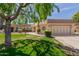 Charming single story home with a well-manicured lawn, mature landscaping, and a two car garage at 10461 W Hutton Dr, Sun City, AZ 85351