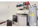 Functional laundry area with modern washer, dryer, and storage shelves, creating an efficient space at 10461 W Hutton Dr, Sun City, AZ 85351
