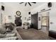 Spacious living room showcasing a large sectional sofa, a modern ceiling fan, and sliding barn doors at 10461 W Hutton Dr, Sun City, AZ 85351