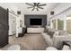 Open-concept living room featuring neutral tones, a modern ceiling fan, and sliding barn doors at 10461 W Hutton Dr, Sun City, AZ 85351