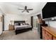 Serene main bedroom with neutral tones, ceiling fan, and ample natural light creating a tranquil retreat at 10461 W Hutton Dr, Sun City, AZ 85351