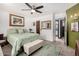 Comfortable main bedroom featuring a ceiling fan, ensuite bathroom, and stylish decor, providing a relaxing retreat at 10461 W Hutton Dr, Sun City, AZ 85351