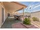 Inviting covered patio with dining set and BBQ, perfect for outdoor entertaining and relaxation at 10461 W Hutton Dr, Sun City, AZ 85351