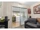 Cozy sunroom with natural light, sliding door to garage, and comfortable seating for relaxation and enjoyment at 10461 W Hutton Dr, Sun City, AZ 85351