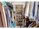 Well-organized walk-in closet with custom shelving for clothing, shoes, and accessories, maximizing storage space at 10461 W Hutton Dr, Sun City, AZ 85351