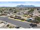 An aerial view highlights the home's location, yard, and surrounding neighborhood with mountain views at 1057 W Mesquite Ave, Apache Junction, AZ 85120