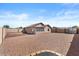 A spacious backyard features a stone ground cover, a block wall, and the exterior of the home at 1057 W Mesquite Ave, Apache Junction, AZ 85120