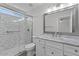 Well-lit bathroom featuring shower, marble finishes, and vanity at 1057 W Mesquite Ave, Apache Junction, AZ 85120