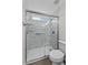 Glass shower with marble surround, shower seat, and handrails at 1057 W Mesquite Ave, Apache Junction, AZ 85120