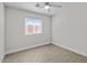 Bedroom featuring ceiling fan, neutral walls, and a window at 1057 W Mesquite Ave, Apache Junction, AZ 85120