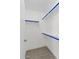 Bright walk-in closet featuring shelving and blue rods at 1057 W Mesquite Ave, Apache Junction, AZ 85120