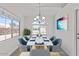 Staged dining room showcases bright light from the large window, complete with table and six chairs at 1057 W Mesquite Ave, Apache Junction, AZ 85120