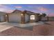 Charming single story home featuring brick accents, a two-car garage and desert landscaping at 1057 W Mesquite Ave, Apache Junction, AZ 85120