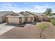 A charming single-Gathering home features a large garage, brick accents, and a well-maintained yard at 1057 W Mesquite Ave, Apache Junction, AZ 85120