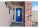 An inviting entryway featuring a blue front door with decorative window and sidelight at 1057 W Mesquite Ave, Apache Junction, AZ 85120