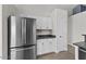 Open concept kitchen features stainless steel refrigerator and ample cabinet space, with gray countertops at 1057 W Mesquite Ave, Apache Junction, AZ 85120