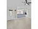 Bright and airy living space with stylish flooring, ceiling fan, and open view of kitchen at 1057 W Mesquite Ave, Apache Junction, AZ 85120