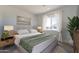 Inviting bedroom features a comfortable bed, a large window, and stylish nightstands with lamps at 10829 W Woodruff Rd, Casa Grande, AZ 85194