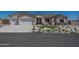 Charming single-story home boasting a well-maintained front yard with stone landscaping and a three-car garage at 10829 W Woodruff Rd, Casa Grande, AZ 85194