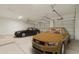 Spacious three car garage with two luxury sedans parked inside at 10829 W Woodruff Rd, Casa Grande, AZ 85194