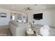 Spacious living room with a ceiling fan, neutral decor, and a view of the entry hallway and furniture at 10829 W Woodruff Rd, Casa Grande, AZ 85194