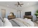 Comfortable main bedroom with natural light, a ceiling fan, and views of the sliding barn door at 10829 W Woodruff Rd, Casa Grande, AZ 85194