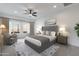 Cozy bedroom with soft lighting, a comfortable sitting area, and large windows with a desert view at 10907 W Woodruff Rd, Casa Grande, AZ 85194