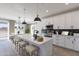 Modern kitchen with white cabinetry, a center island with seating, and stainless steel appliances at 10907 W Woodruff Rd, Casa Grande, AZ 85194