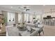 Bright, open-concept living room flows seamlessly into the kitchen with stylish furniture and desert views at 10907 W Woodruff Rd, Casa Grande, AZ 85194