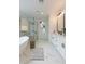 Spa-like main bathroom featuring a soaking tub, glass-enclosed shower, and double vanity at 10907 W Woodruff Rd, Casa Grande, AZ 85194